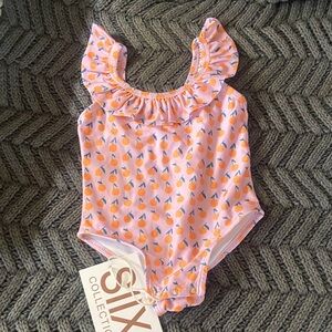 Pink Ruffled Baby Swimsuit with sweet orange print.